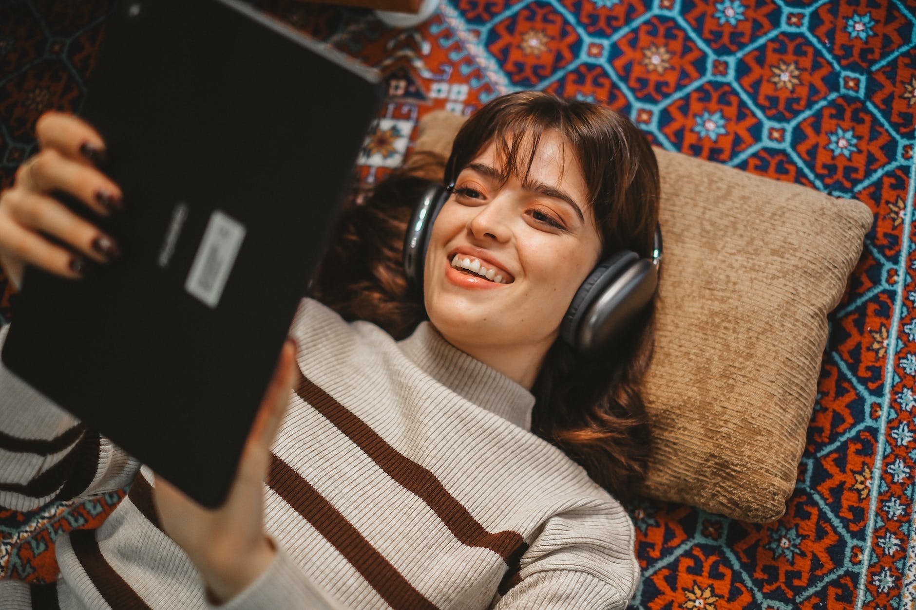 woman using laptop and headphones